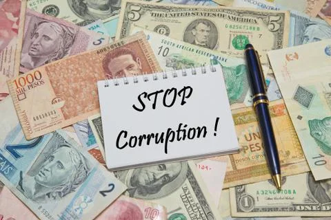 Notebook page with text STOP CORRUPTION, background from different world Currenc Stock Photos