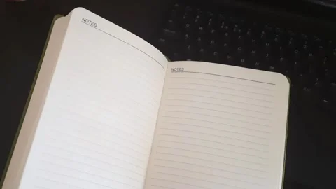 Notebook Pages Gently Waving on Laptop Workspace Video stock 336064729