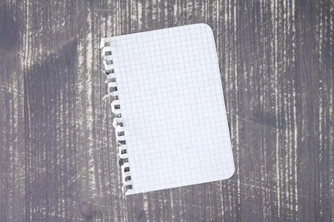 Notebook paper on wood background Stock Photos