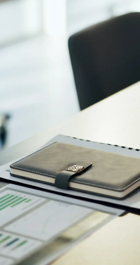 Notebook, paperwork and desk in empty office with charts, graphs or statistics Stock Footage 335269146