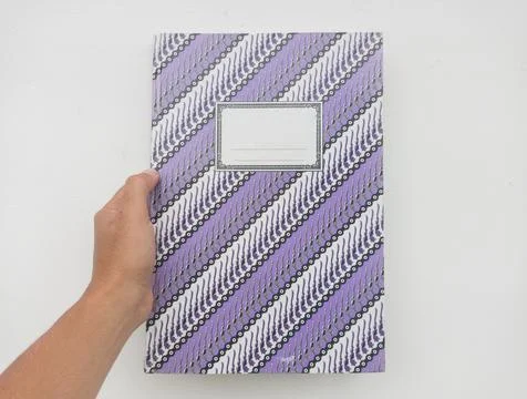 Notebook with patterned cover and hand Stock Photos