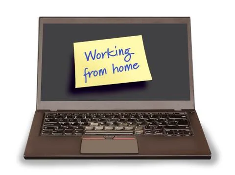 Notebook pc with a yellow sticky note saying Working from home Stock Photos