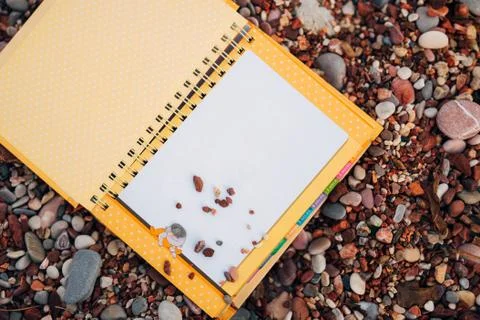 A notebook on a pebble beach Stock Photos