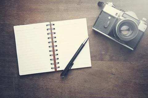 Notebook with pen and camera Stock Photos