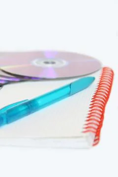 Notebook with pen and cds Stock Photos