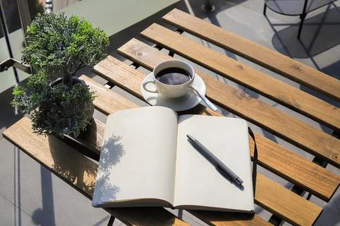Notebook with pen and coffee on the table Stock Photos