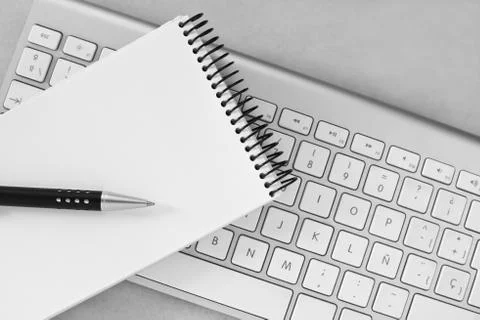 Notebook, pen and computer keyboard Stock Photos
