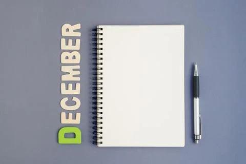Notebook with pen and December month wording Stock Photos