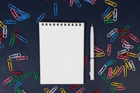 Notebook with a pen on a blue background Stock Photos