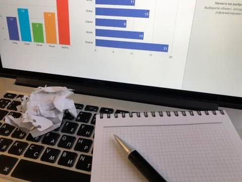 Notebook with pen on laptop keyboard Stock Photos