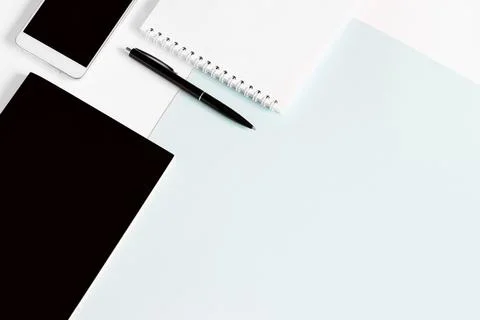 Notebook, pen, smartphone, office tools, flat lay on a light blue background, Stock Photos