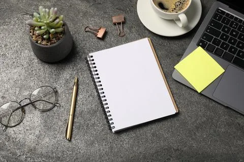 Notebook, pen, sticky note, coffee, glasses, floral decor and laptop on gre.. Stock Photos