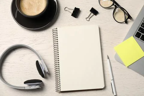 Notebook, pen, sticky note, glasses, coffee, headphones and laptop on white.. Stock Photos