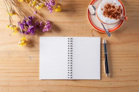 Notebook with pen on wood table Stock Photos