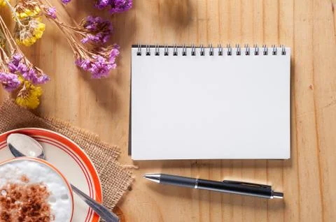 Notebook with pen on wood table Stock Photos
