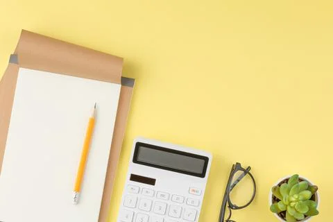 Notebook with pencil on yellow background Stock Photos
