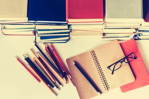 Notebook, pencils, glasses and stack of books, school background for educatio Stock Photos