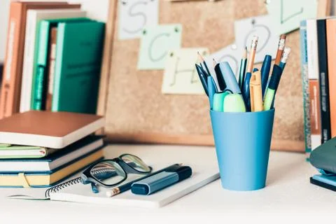 Notebook, pencils, glasses and stack of books, school background for educatio Stock Photos