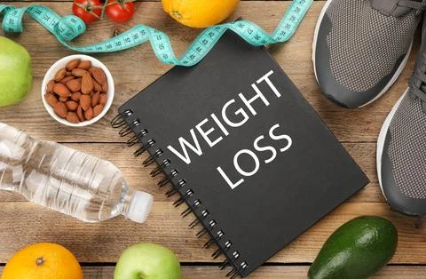 Notebook with phrase Weight Loss Program, sneakers and different products o.. Foto stock