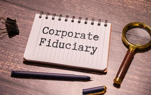 A notebook with a piece of paper that white notepad and text Corporate Fiduciary Stock Photos