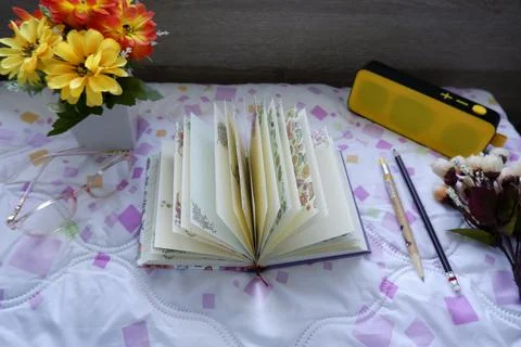 The notebook is placed in the bed Stock Photos