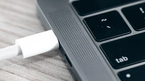 Notebook power and data cable connection Stock Photos