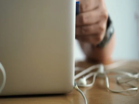 Notebook power wire line and headphone tangle while working Stock-Footage 79568541