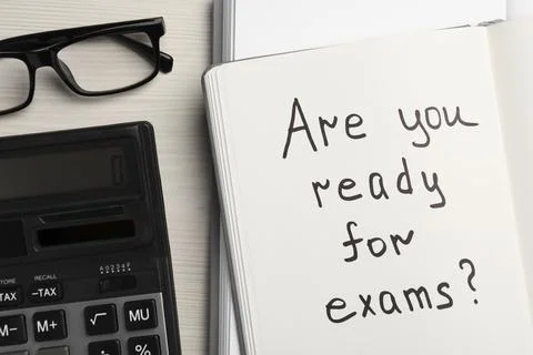 Notebook with question Are You Ready For Exams? on white wooden table, flat l Stock Photos