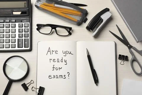 Notebook with question Are You Ready For Exams? on white wooden table, flat l 写真素材