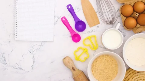 Notebook for recipe appear on marble table with cooking supplies - Stop motion Vidéo 128577781