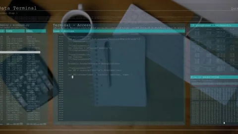 Notebook resting on desk, Data Terminal overlay fading in and populating code Stock Footage 330355294