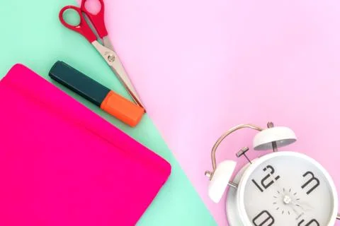 Notebook, scissors and an alarm clock Stock Photos
