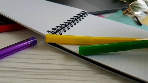 Notebook scratch pens on the desktop Stock Footage 90063096