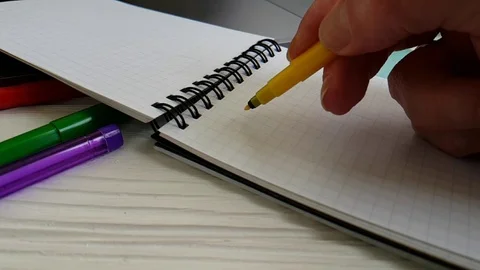 Notebook scratch pens on the desktop slow-motion shooting hand draws Stock Footage 90063554