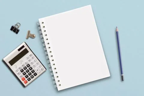 The notebook is set on a blue paper background. Stock Photos