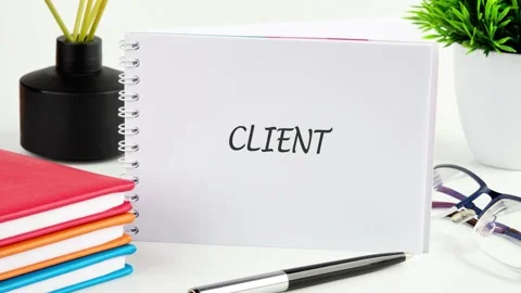 A notebook shows letters Client changing from unclear to clear in an office Stock Footage 339321812