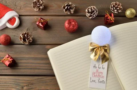 Notebook with space for text with Christmas decorations on a wooden backgroun Fotos de archivo