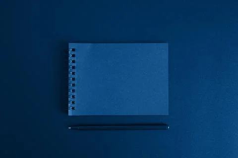 Notebook on a spring and a pen on a black background. space for text. toned c Stock Photos
