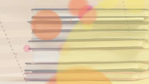 Notebook stack centered while soft circles emerging from lower right, expanding Stock Footage 333911387