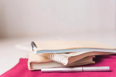 Notebook stack, pen, pencils. Schoolchild and student studies accessories. Back Foto stock