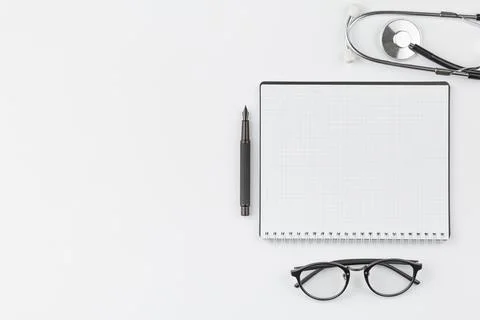 Notebook with stethoscope and glasses. Stock Photos