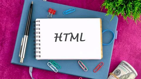 Notebook on a Table With HTML Written on the Cover, Surrounded by Office Su.. Stock Photos