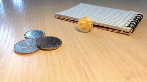 Notebook on the table m coins Stock Footage 123689139