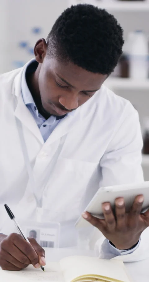 Notebook, tablet and scientist in laboratory with writing for medical research Stock Footage 336734926