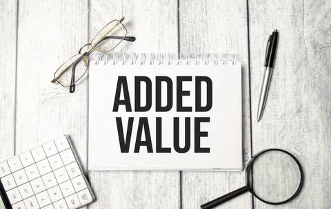Notebook with the text added value. Close-up of the workplace. Business conce Stock Photos