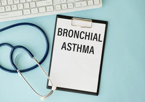 In the notebook is the text bronchial asthma, next to a stethoscope, pills .. Stock Photos