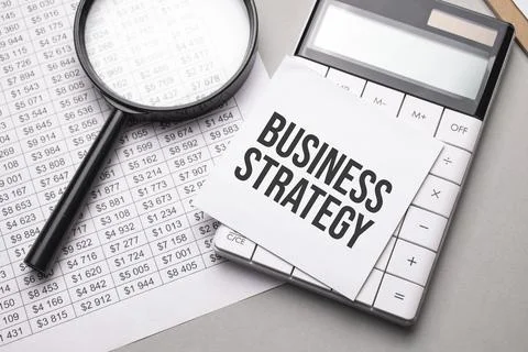 Notebook with text BUSINESS STRATEGY sheet of white paper for notes, calculat Stock Photos