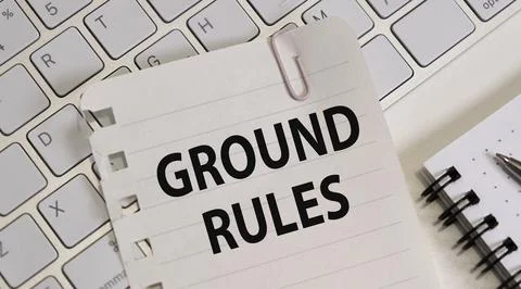 Notebook with text GROUND RULES and pen on wooden table, top view Stock Photos