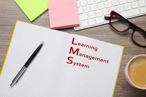 Notebook with text Learning Management System on wooden table, flat lay Stock Photos