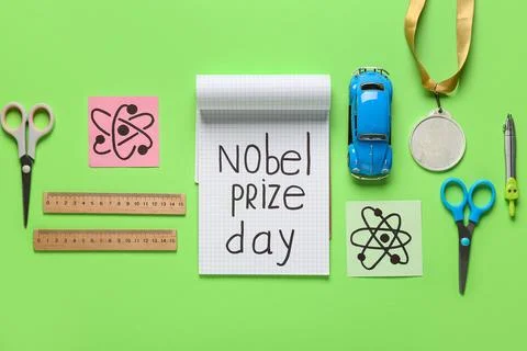 Notebook with text NOBEL PRIZE DAY, medal, drawn molecules and stationery on  Stock Photos